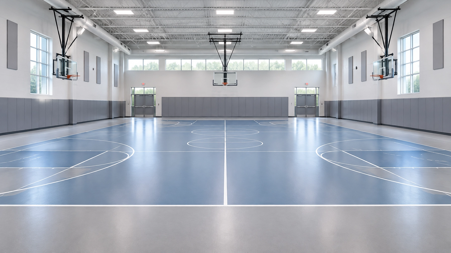 Bright indoor basketball court with three hoops