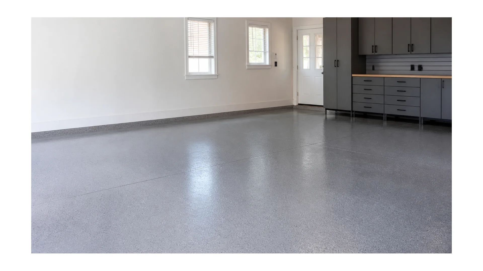 Finished gray epoxy flooring in a clean garage and workshop interior