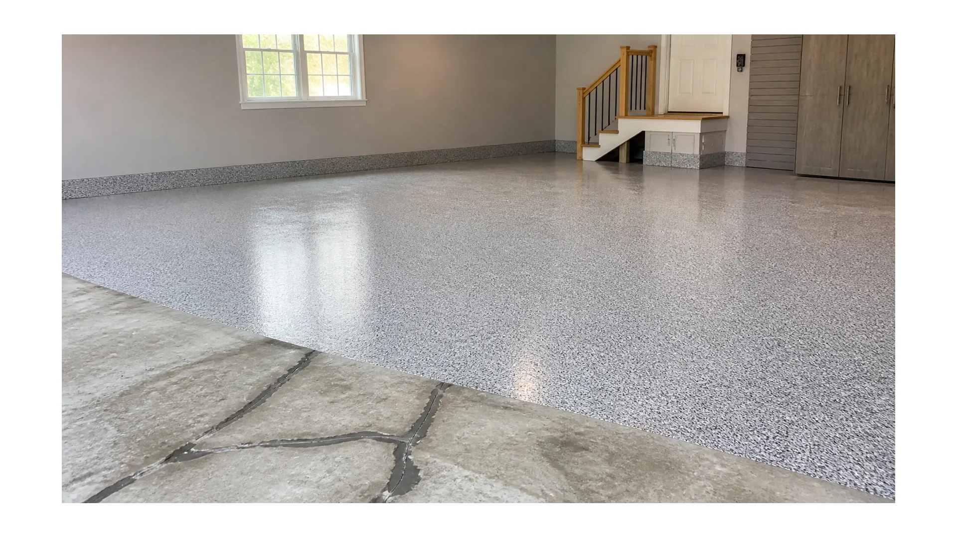 Residential cracked concrete repair transitioning into finished flake epoxy flooring